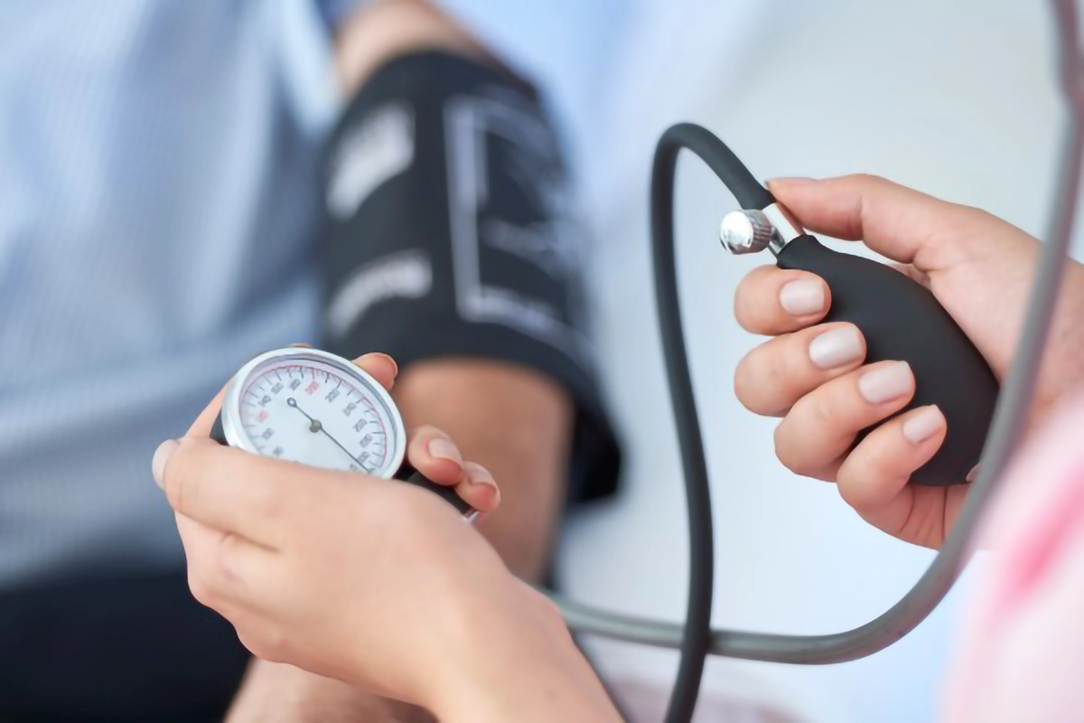 Image show a patient having a their blood pressure taken